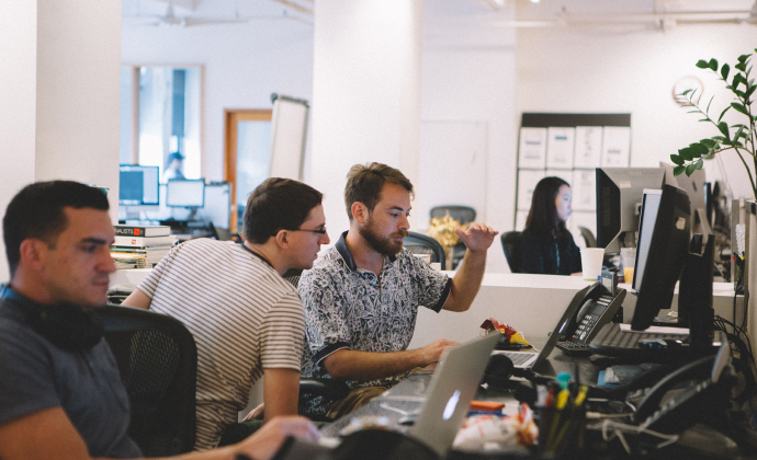 Discussion in front of computers about how best to implement some piece of code.